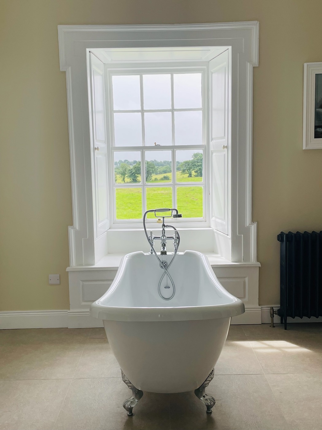 A roll-top bath with estate views