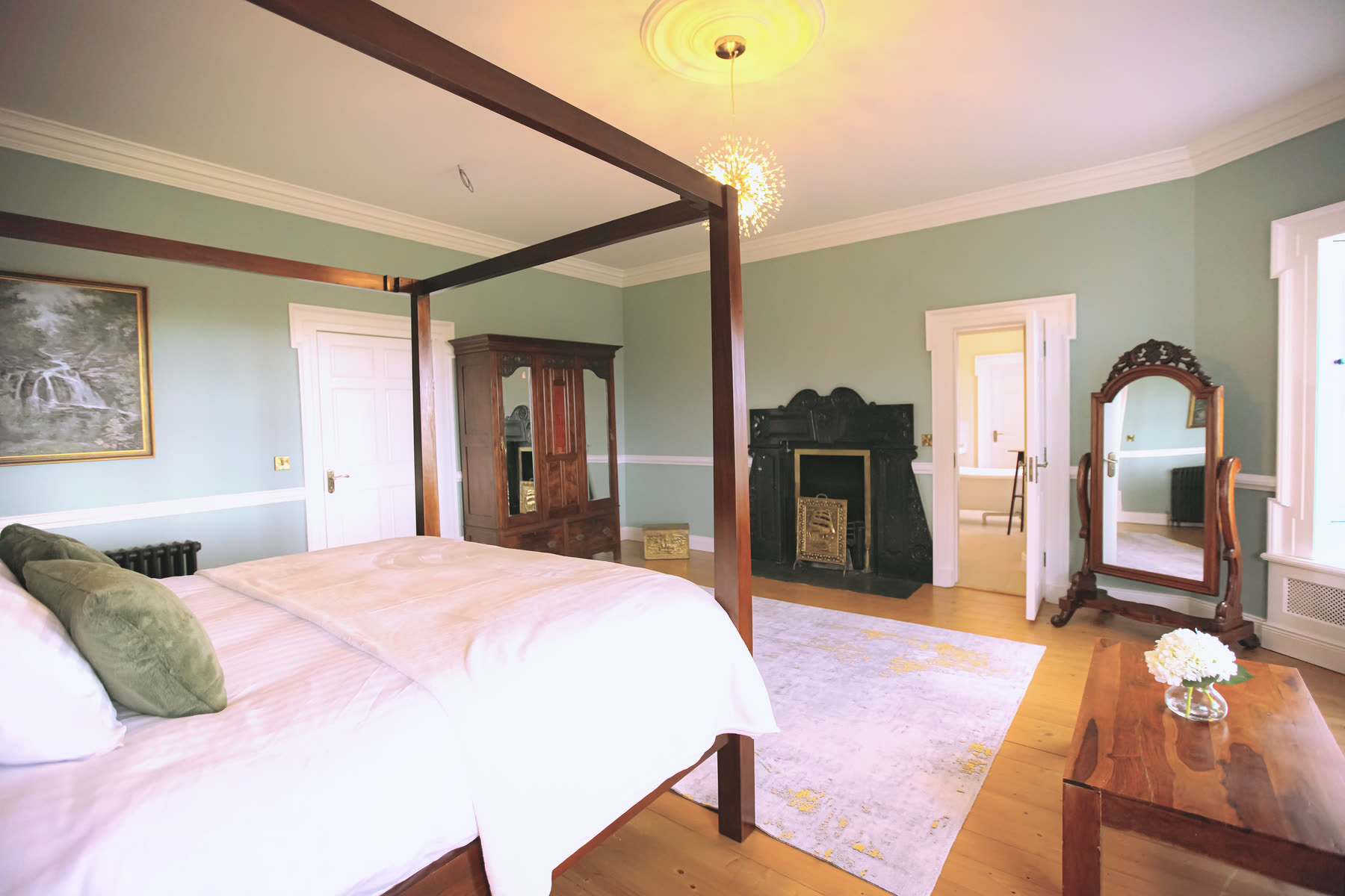 A guest bedroom with a four-poster bed